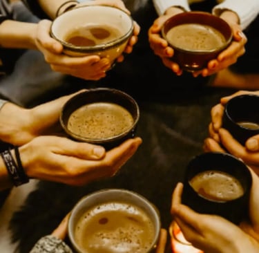 Many hands sharing a cup of cacoa