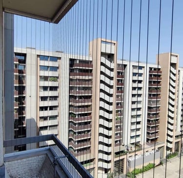 a balcony invisible grill with a view of a city skyline