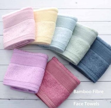 a variety of colored bamboo fibre face towels on a white table