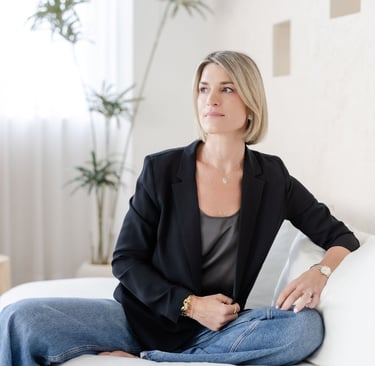 Psychotherapist Yvonne smiling, soft lighting, reflective and calm expression.