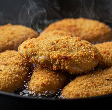 a pan of fried fried chicken nuggling in a skillet