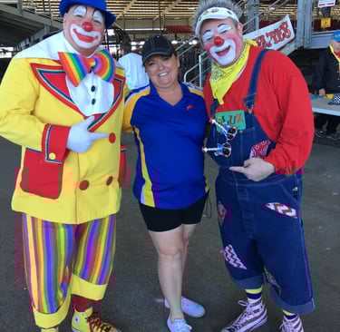 Deanna the Inspector standing next to 2 clowns