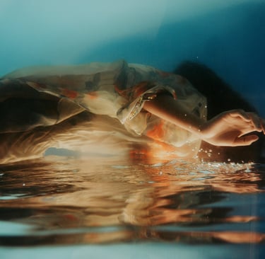 a person holding a hand in the water