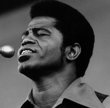Black and White Portrait of James Brown on Stage singing into a microphone