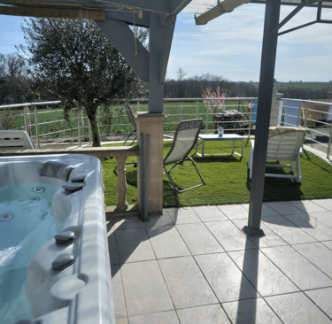 a hot tub in a backyard with a patio table and chairs