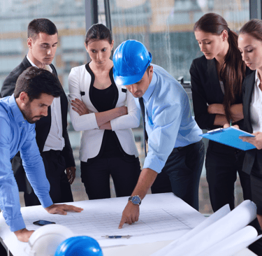 Project Manager analyzing a strategic plan at a work desk.