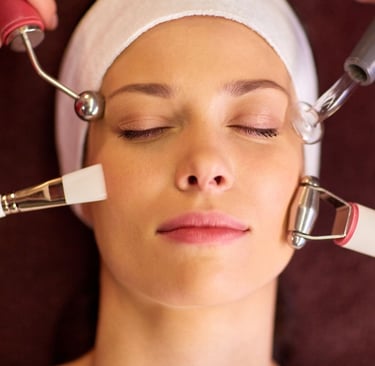 a woman getting her face massager done by a professional