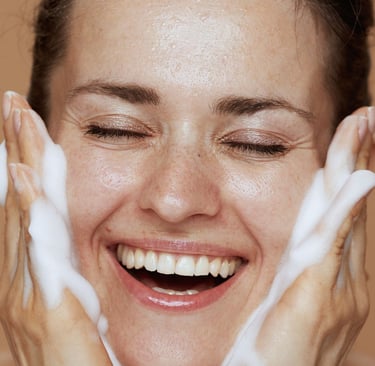 a woman with her hands on her face and smiling