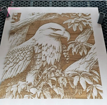 Engraved eagle and branches on pinewood