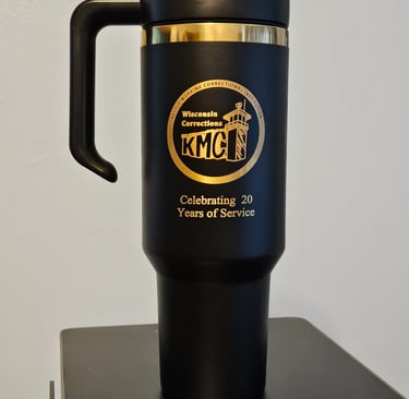 a black and gold mug with a logo on it