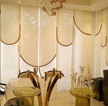 a table with a glass table top and chairs and beautiful Curtains