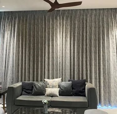a living room with a couch and a ceiling fan