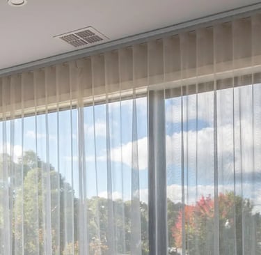 a bed room with a large window and a bed