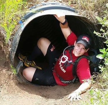 Texas Spartan female racer upcoming out of tunnel