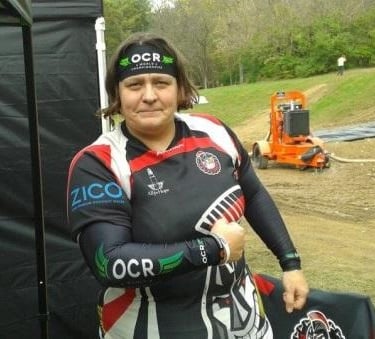 a woman in a black and white outfit holding a bag