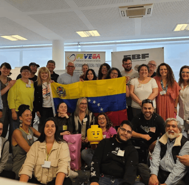 Grupo de personas mirando a la cámara, sosteniendo la bandera de Venezuela.