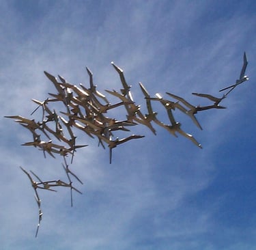 Abstract sculpture of zinc plated steel flock of  Tasmanian shearwater birds