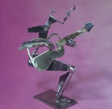 a metal sculpture of a man playing guitar