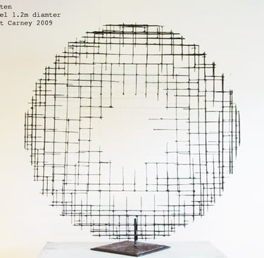 a steel cross-hatched circle sculpture  