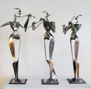 three statues of cubist musicians playing instruments