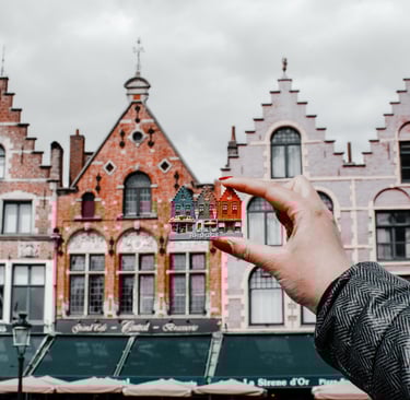 a person holding a miniature model of a miniature fire hydrant