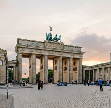 a group of people standing around a large building