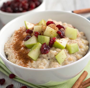 a bowl of oatmeal with apples and cinnamon