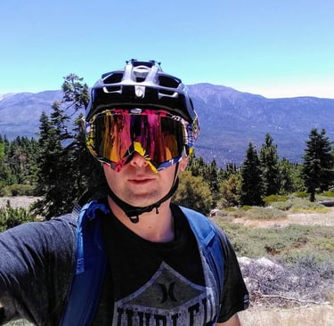 mountain biker with goggles over half shell helmet