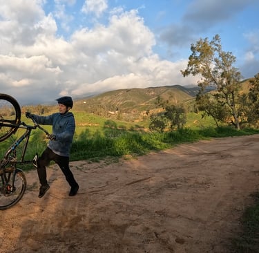 mountain biker safely bailing out of a wheelie