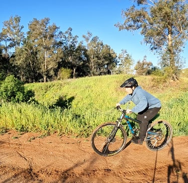 Mountain biker preloading before doing a J hop