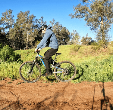 Mountain biker leveling the bike out on a j hop