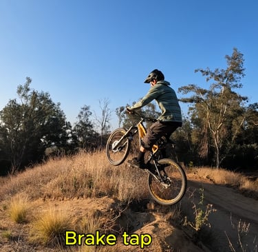 mountain biker tapping rear brake mid air to bring the front wheel down