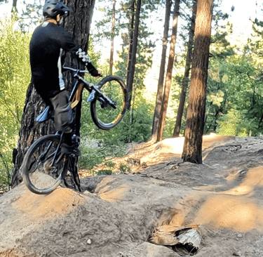 Mountain biker extending off the top of a jump with proper form