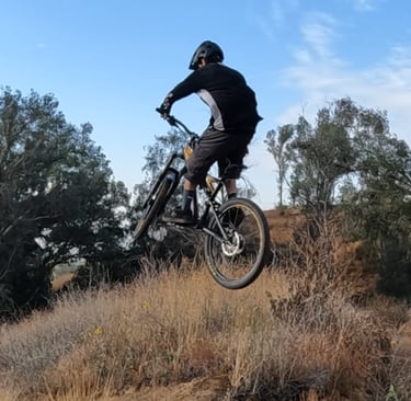 Proper neutral jump landing — rider level in the air with balanced body position and smooth bike ang