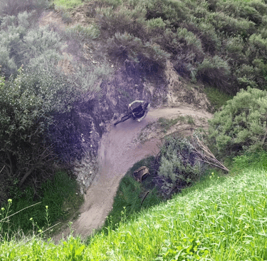 Mountain biker going around corner at hulda crooks park in loma linda