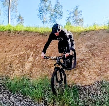 mountain biker halfway down a steep drop in