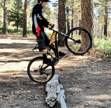 mountain biker exploding upwards with the bump jump technique