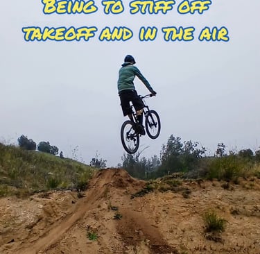 "Mountain biker stiff in the air with extended arms and legs