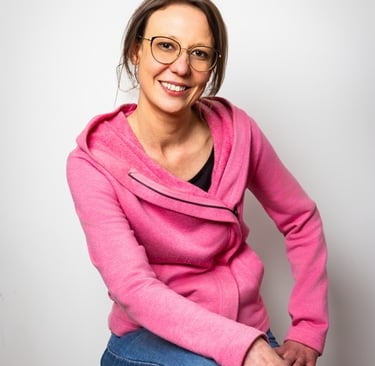 Femme assise sur un tabouret devant un fond blanc