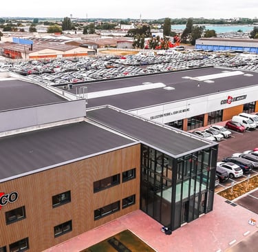 a large building with a lot of cars parked in front of it
