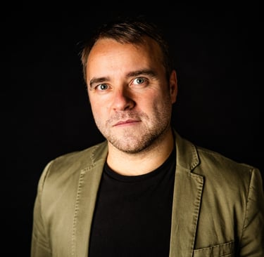 a man in a jacket and a black shirt