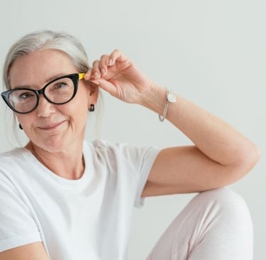 a woman with glasses and a white shirt