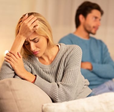 a man and woman sitting on a couch in a living room