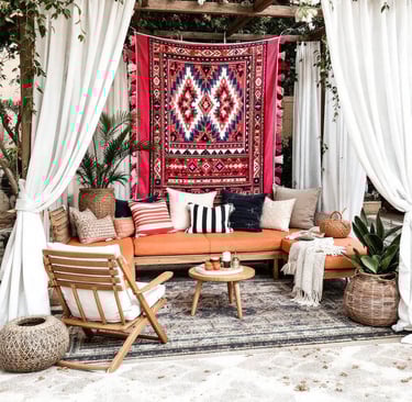a boho garden patio with a couch and a rug 