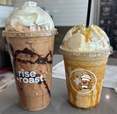 two cups of coffee and a drink in a coffee shop