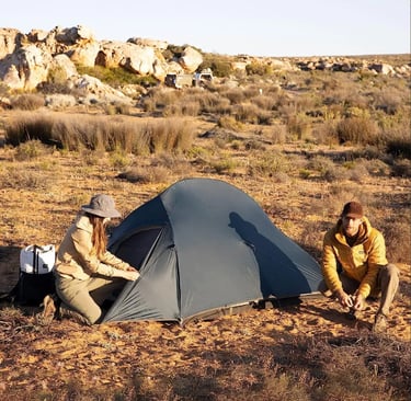 a man and woman setting up a tent