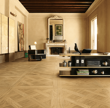 a living room with a large wooden floor and a fireplace