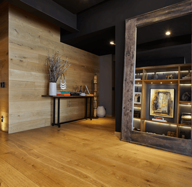 a hallway with a wooden floor and a mirror