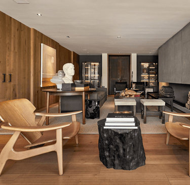 a living room with a large stone fireplace and a large stone fireplace