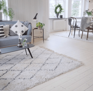 a living room with a couch and chairs